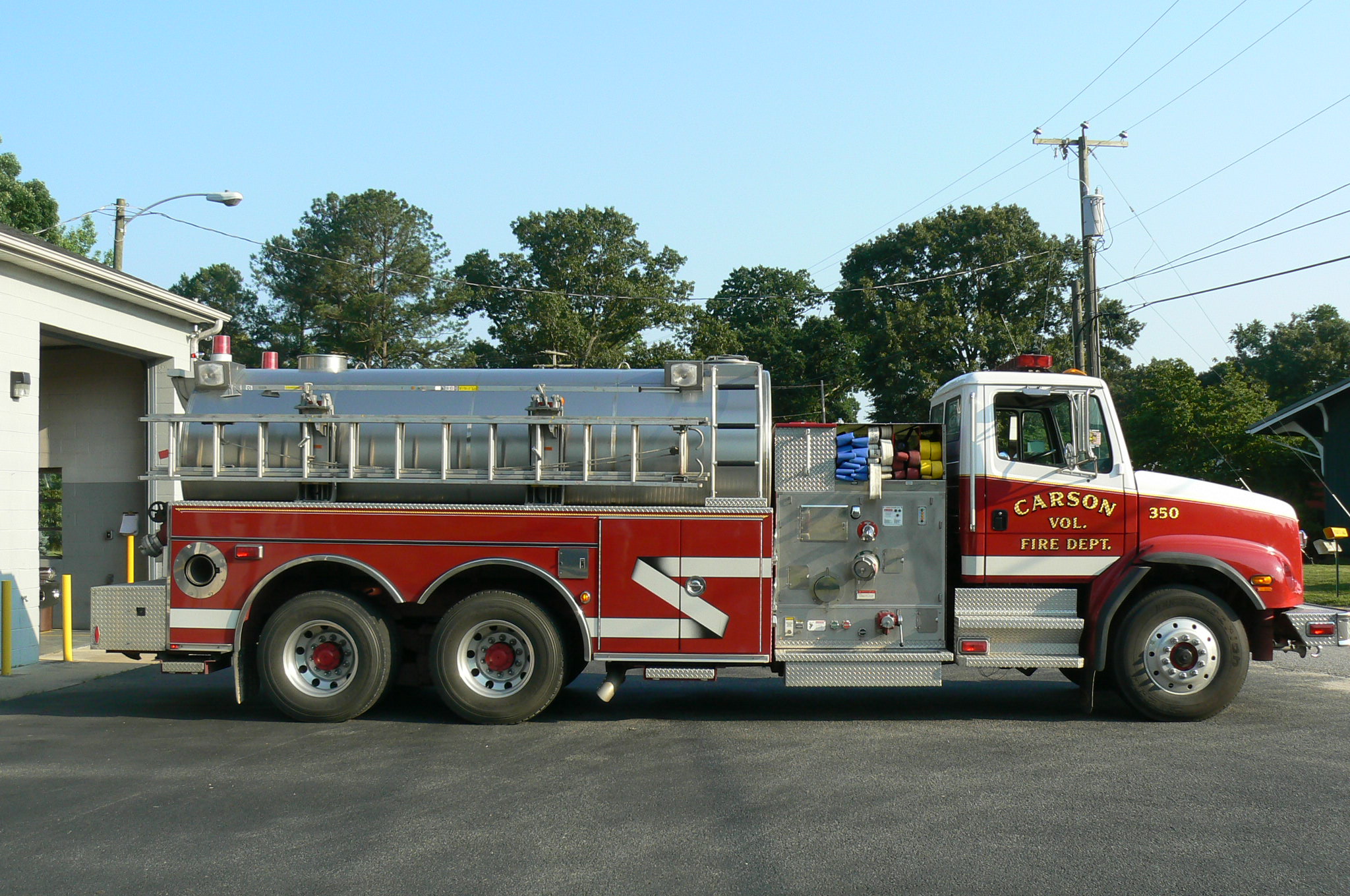 Red fire tanker with ladder